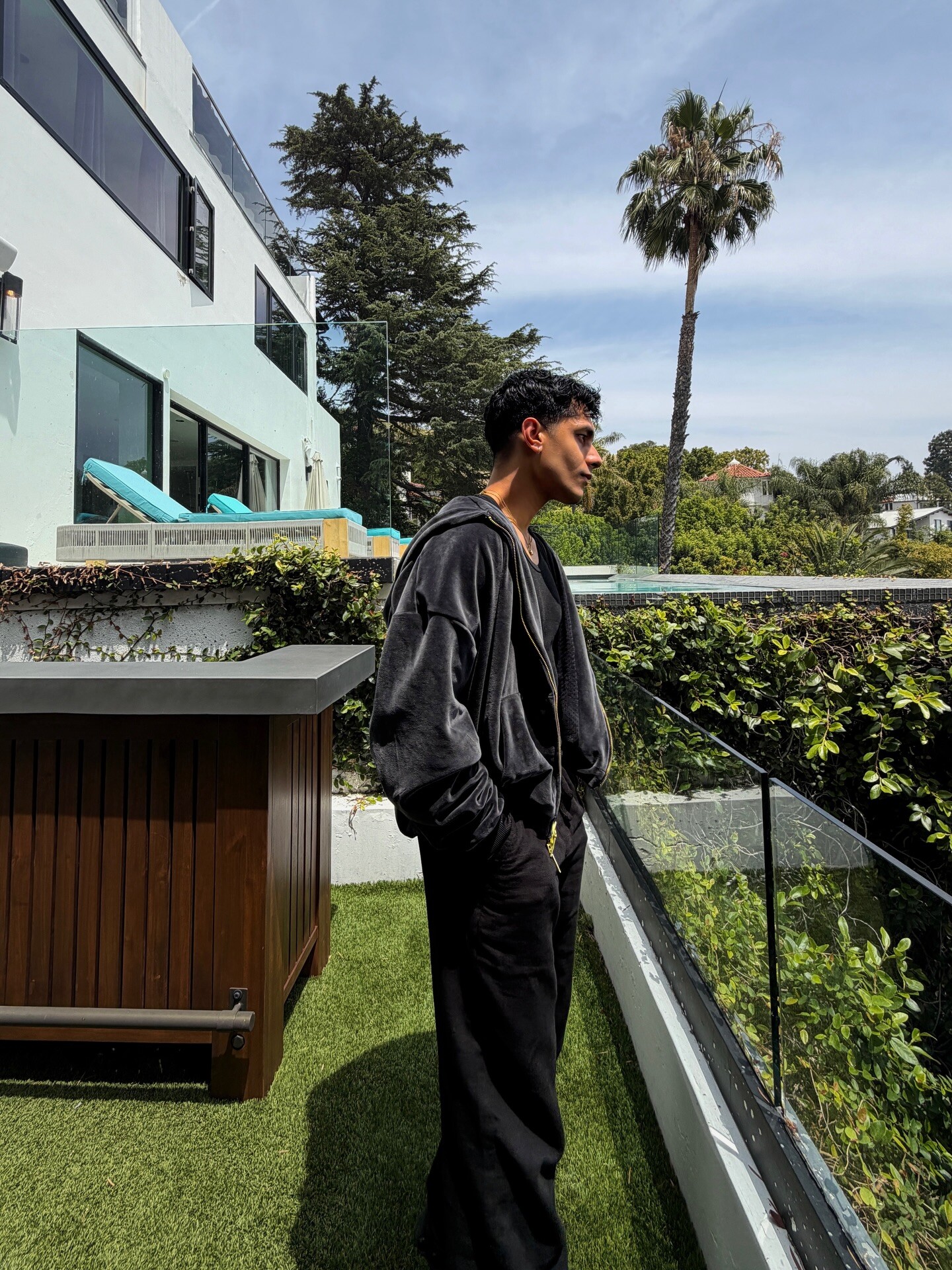 Aryan Mahajan wearing a black jacket on a Los Angeles terrace
