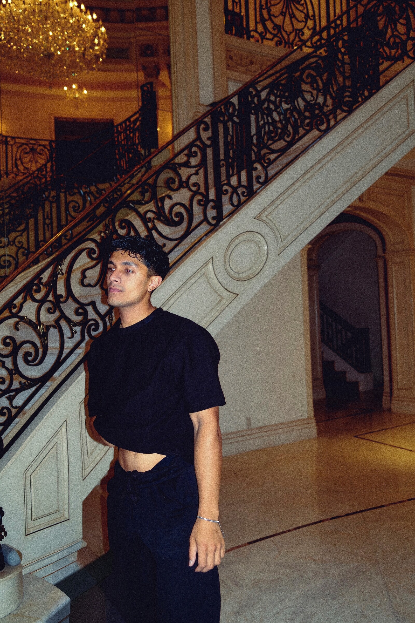 Aryan Mahajan standing beside a grand staircase