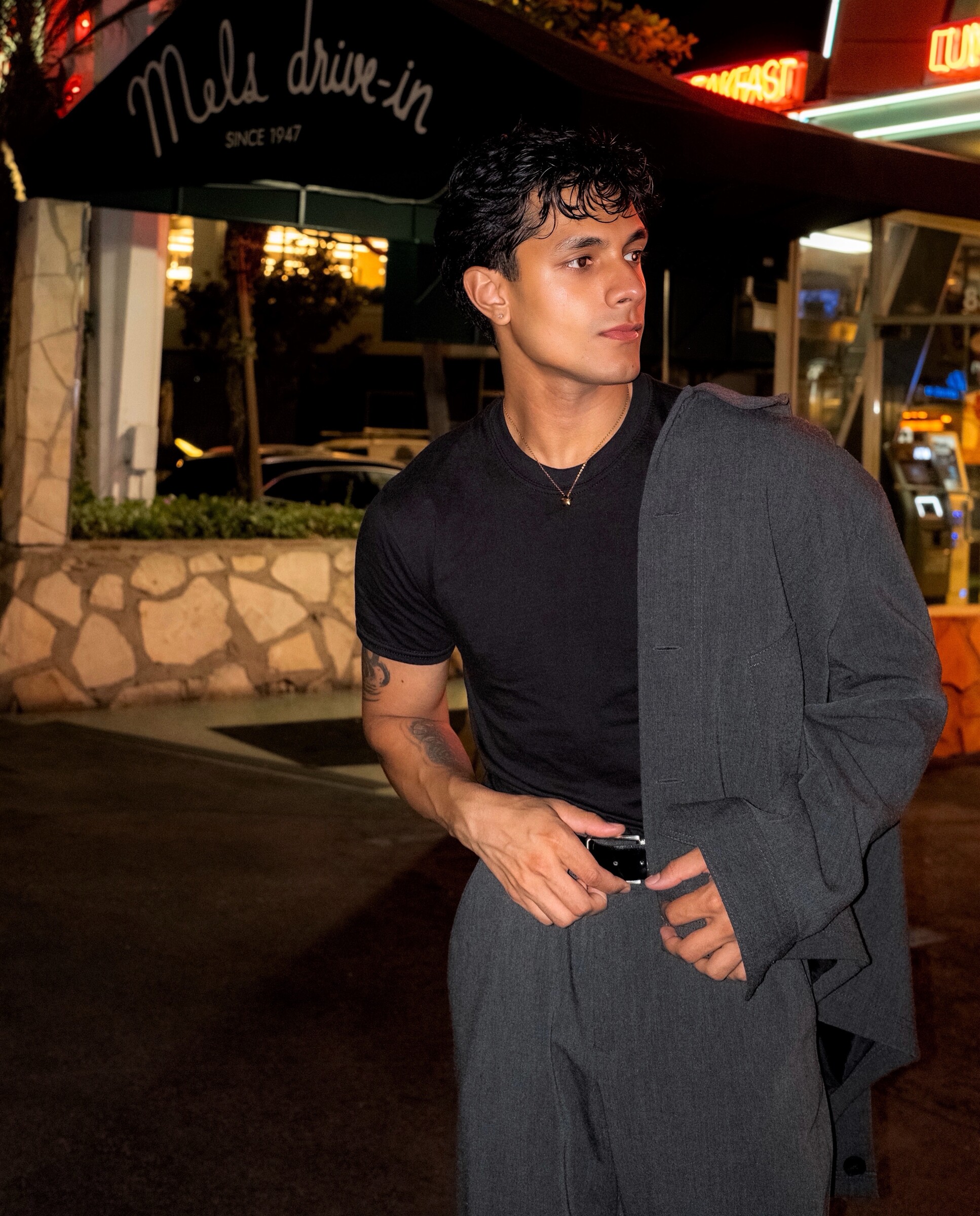 Aryan Mahajan wearing gray at Mel's Drive-In in Los Angeles