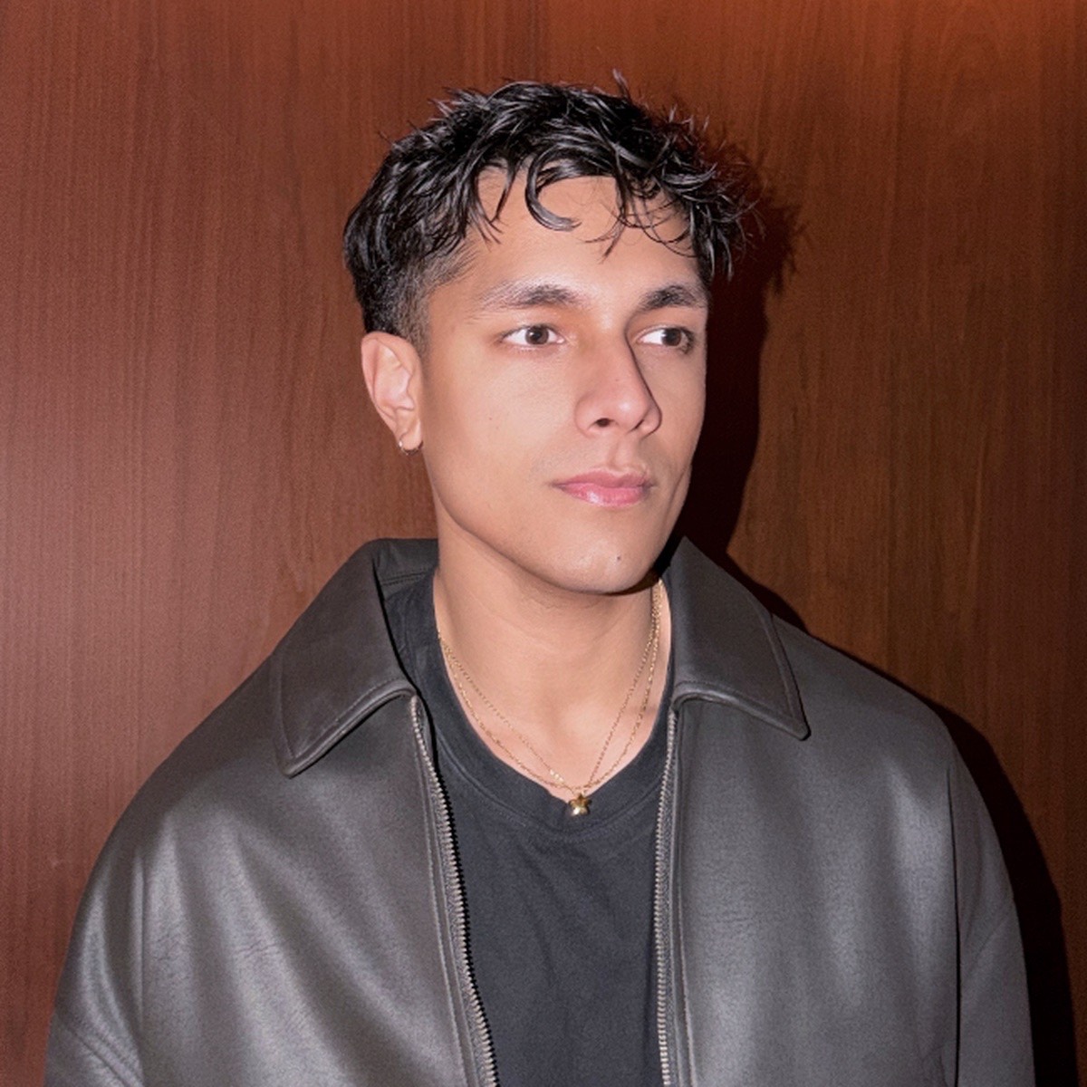 Close portrait of Aryan Mahajan wearing a black leather jacket