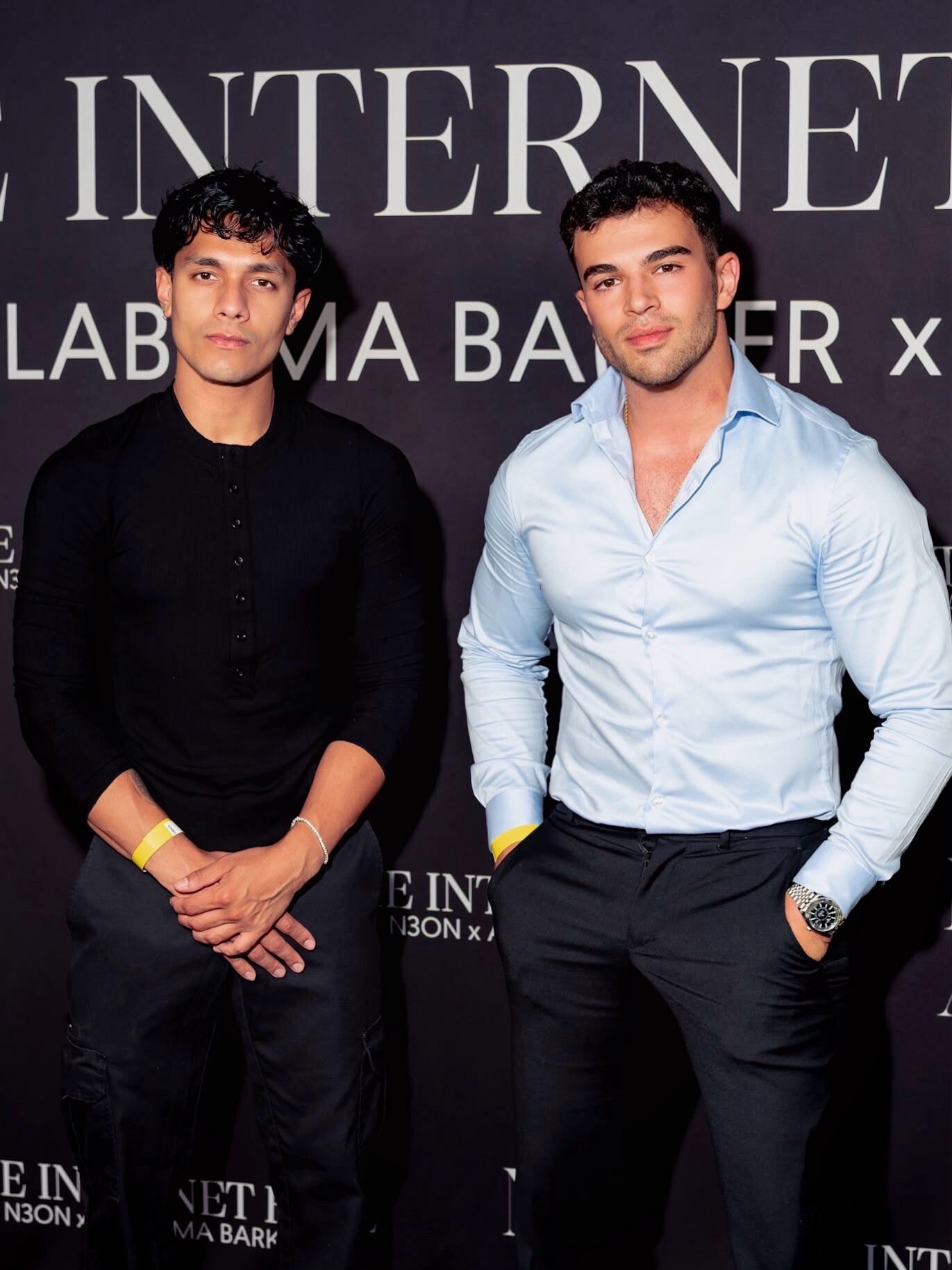 Aryan Mahajan and another attendee posing in front of an event backdrop