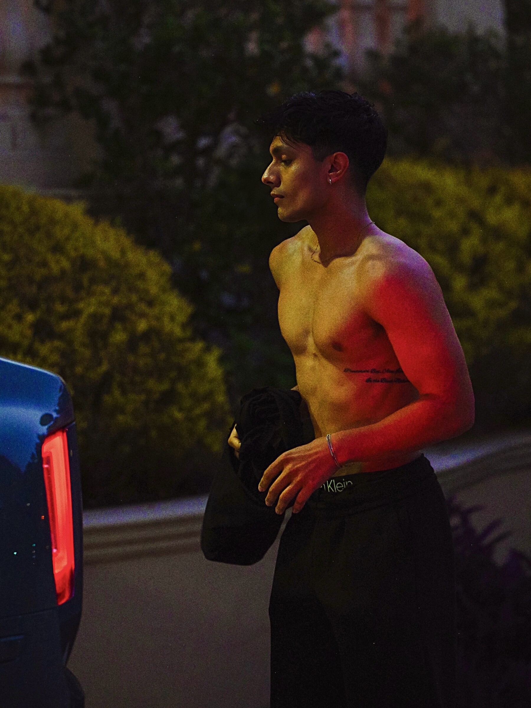Shirtless night portrait of Aryan Mahajan under red light